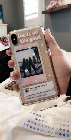 someone is holding up their cell phone to take a photo with the message focus on the good