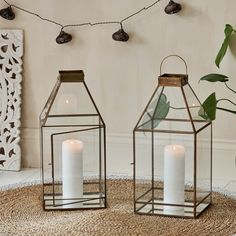 two glass lanterns sitting on top of a rug