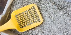 a yellow grater sitting on top of a pile of gravel