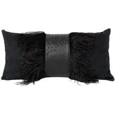 a black pillow with feathers on the front and side, sitting against a white background