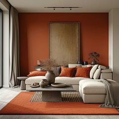 an orange and white living room with couches, coffee table, rugs and large windows