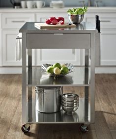 a stainless steel kitchen cart with pots and pans on it