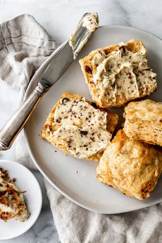 a white plate topped with pastries next to a fork