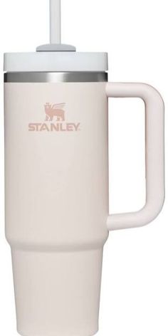 a white travel mug with a straw sticking out of it's top and handle