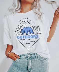 The Great Outdoors graphic tee with illustration of a wild bear in the woods surrounded by nature with the message "Go out and stay out". Great apparel gift for campers, hikers, travelers, wanderlust, outdoors and nature lovers. ** ABOUT PRODUCT** This classic unisex jersey short sleeve tee fits like a well-loved favorite. Soft cotton and quality print make users fall in love with it over and over again. These t-shirts have ribbed knit collars to bolster shaping. The shoulders have taping for be Tropical Svg, Vsco Shirts, Library Shirt, Book Nerd Shirts, Nerd Shirt, Boho Tropical, Texas Shirts, Space Shirts, Western Graphic Tees