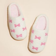 Put your best (and cosiest) foot forward with our Little Pink Ribbons Home Slippers! These playful and quirky slippers feature adorable pink ribbons that will add a touch of fun to your at-home lounging. Made with comfort in mind, these slippers are the perfect addition to your self-care routine. Small: Womens size 6-7 Medium: Womens size 8-9 Large: Womens Size 10-11 Cute Flat Indoor Slippers, Super Soft Pink Slip-on Slippers, Cute Soft Flat Slippers, Cute Round Toe Slippers For Loungewear, Playful Indoor Synthetic Slippers, Cute Soft Slippers For Indoor Use, Cute Soft Indoor Slippers, Cute Soft Slippers For Loungewear, Playful Pink Non-slip Slippers