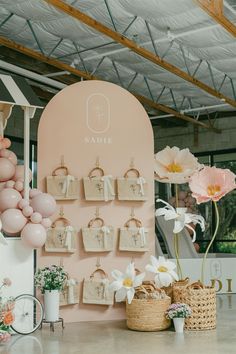 there are many bags on the wall and flowers in vases next to each other