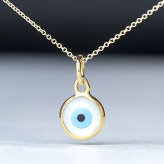 Small round 14k solid gold evil eye pendant.  The pendant measures 8mm / 0.3 inches Ring/bail opening is 4mm The evil eye pendant is available in 14k yellow gold with a white evil eye.  The  eye is made of mother of pearl (mop). The pendant is the same front and back and can be worn either way. Available with a solid 14k gold chain or as pendant only. Chains are available in 3 lengths, 16inches/40cm, 18inches/45cm and 20 inches/50cm Perfect gift for Valentine or any other special occasion. Comes 14k Gold Evil Eye Necklace, 14k Gold Evil Eye Round Necklace, White Evil Eye Round Pendant Necklace, White Round Pendant Necklace With Evil Eye, White Evil Eye Jewelry, Round Evil Eye, Eye Pendant, Evil Eye Pendant, Evil Eye Necklace