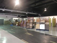 a large room with lots of different types of wood flooring in the center and various colors on the walls