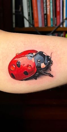 a ladybug tattoo on the right arm