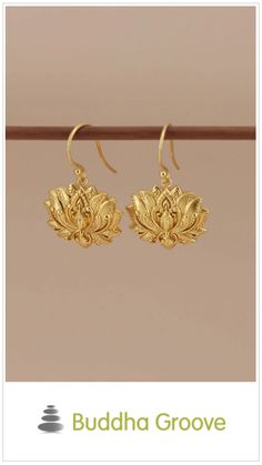 Gold lotus flower earrings, hanging on a display rod. Elegant Lotus Flower Jewelry For Wedding, Traditional Gold Flower Earrings With Ear Wire, Traditional Gold Flower Earrings, Graceful Gold Earrings, Elegant Brass Earrings With Flower Charm, Graceful Gold Teardrop Earrings, Graceful Gold Dangle Earrings, Gift Flower Earrings With Latkans, Gold Spiritual Drop Earrings