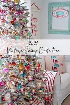 a white christmas tree with ornaments on it and the words vintage shiny brontee