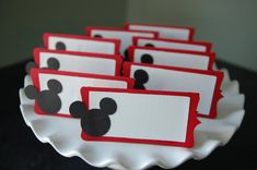 mickey mouse food labels on a plate with red and white tags attached to them,