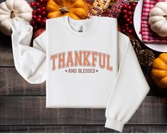 Elevate your Fall and Thanksgiving wardrobe with this cozy women's longsleeve crewneck featuring a slogan "Thankful And Blessed," designed for a unisex fit. Made from a medium-heavy 50% cotton and 50% polyester blend, this sweatshirt is perfect for chilly autumn nights. Its classic fit and crew neckline provide a relaxed silhouette, while reinforced double-needle stitching ensures durability and comfort. The gray, tear-away label prevents itchiness for a smooth feel. Stay warm, feel good, and celebrate the Thanksgiving season! *Production & Shipping* -Because all products in our shop are made to order. The current production time is 1-3 business days. -Shipping is an additional time of 1-5 business days until you will receive your items. -Based on your location, expedited shipping may be a Thanksgiving Embroidery, Thankful Sweatshirt, Embroidery Crewneck, Thanksgiving Sweater, Thanksgiving Sweatshirt, Thankful Shirt, Embroidery Sweater, Fall Clothing, Thankful And Blessed