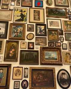 a wall covered with lots of framed pictures