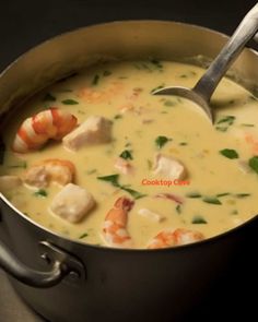 a large pot filled with soup and shrimp