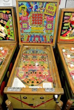 three pinball machines sitting next to each other