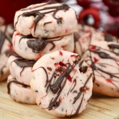 cookies with chocolate drizzled on them sitting on a cutting board