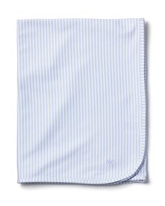 the blue and white striped pocket square is folded on top of an unbuttoned sheet