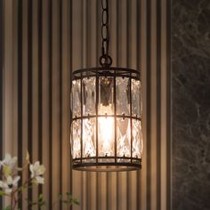 a chandelier hanging over a table with flowers