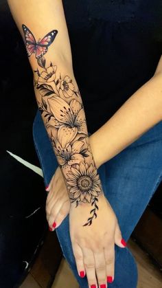 a woman's arm with flowers and a butterfly on it