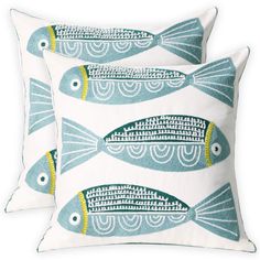 two blue and white fish pillows on a white background with the words m & c