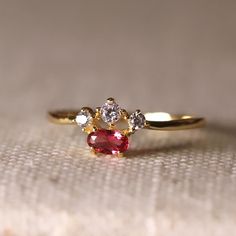 This ring features a beautiful oval cut ruby set in 14k yellow gold and surrounded by natural white diamonds. The rubies are known for their vivid red color, while the diamonds are known for their brilliance and durability. The combination of these precious materials makes this ring a truly luxurious and one-of-a-kind piece.  14k Yellow Gold Stone Setting: Prong Setting Gemstone: 4mm* 5mm * 1pc (100% Natural Red Ruby) Diamond: Brilliant Cut 0. 07caratIS2 clarity G-H color conflict-free white dia Ruby Set, Stone Setting, Gold Stone, Ruby Diamond, Fine Jewelry Designers, Red Ruby, Mens Jewelry Bracelet, Yellow Gold Ring, Diamond Band