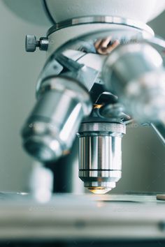 a close up shot of a microscope with focus on the camera lens - stock photo - images