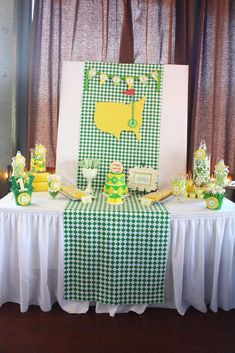 a green and white table cloth on top of a checkered tablecloth covered table