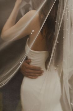 a woman in a white dress under a veil