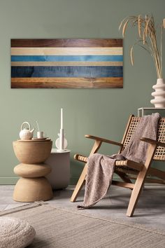 a wooden chair sitting on top of a rug next to a vase