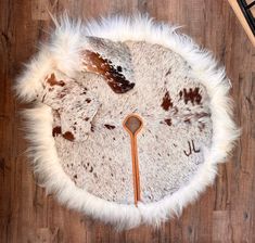 a white and brown animal print rug on top of a wooden floor