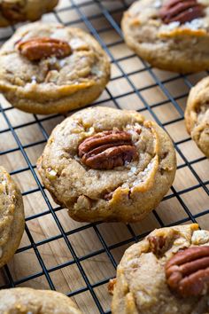 several cookies with pecans and nuts on a cooling rack, ready to be eaten