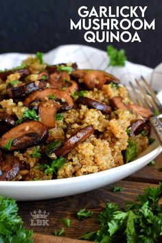 a white plate topped with rice covered in mushrooms and garnished with parsley