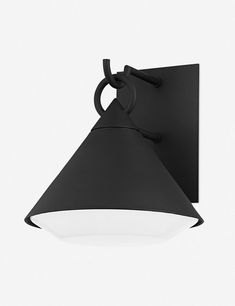 a black wall light with a white light on it's side and an arm hanging from the ceiling