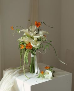 an arrangement of flowers in a vase on a table