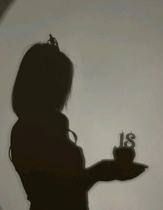 the silhouette of a woman holding a cake with candles in her hand and number thirteen on it