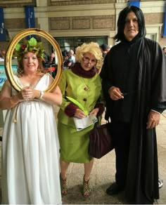 three people dressed up in costumes posing for a photo with an old man and woman