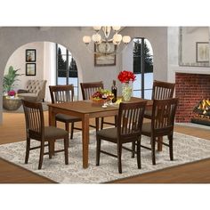 a dinning room table with chairs and a rug in front of a fire place