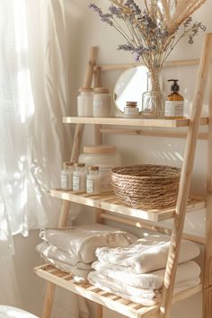 a wooden shelf filled with lots of white towels and other bathroom items next to a window