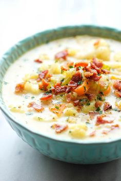 a close up of a bowl of soup with bacon