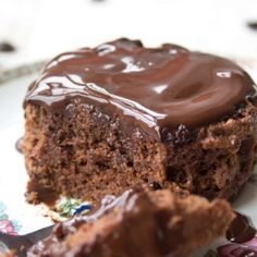 a piece of chocolate cake sitting on top of a white plate