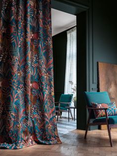 a blue chair sitting in front of a window