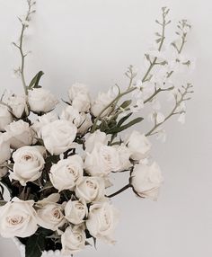 a vase filled with white flowers on top of a table