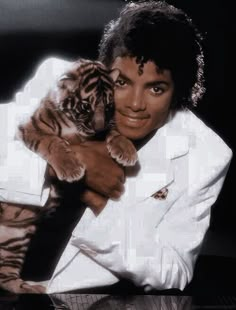 michael jackson holding a tiger cub in his arms