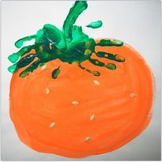 an orange painted with green paint on a white background