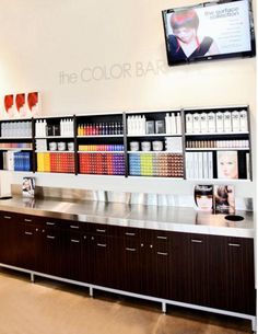 the interior of a coffee shop with lots of counter space and shelves filled with drinks