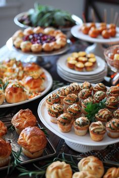 a table topped with lots of different types of pastries and pies on plates