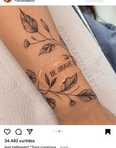 a woman with a tattoo on her arm that says be brave and leaves are around the wrist