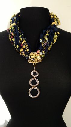 This ribbon scarf/necklace is made with a variety of specialty ribbons and yarns from around the world. Done in shades of blue and yellow    This ribbon scarf necklace come with gold jewelry and an interchangeable pendant.  This is a ResQ™ product so 10% of the profits go to help the fight against human trafficking.  FREE SHIPPING Ribbon Scarf, Beaded Scarf, Scarf Necklace, Ann Arbor, Arbor, Shades Of Blue, Beaded Jewelry, Gold Jewelry, Handmade Jewelry